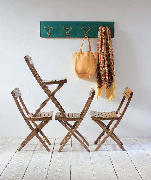 Italian Folding Chairs, Brass Coat Rack, and Leather Tote